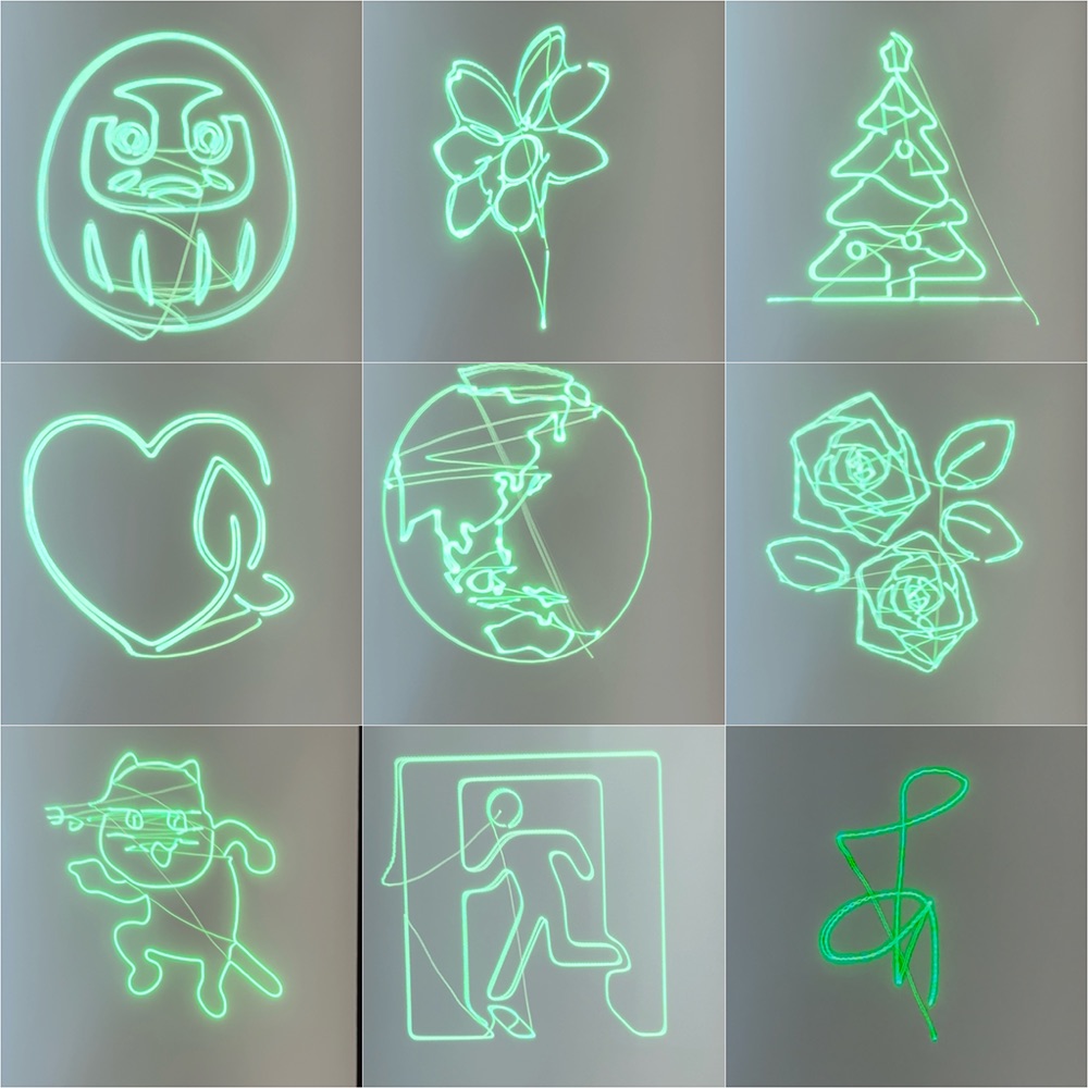 レーザーで描画した作品9点。だるま、花、クリスマスツリー、ハート、地球、バラ、猫、非常口のピクトグラム、サインの線画。